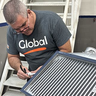 Global AirServices, LLC technicians working on aircraft components