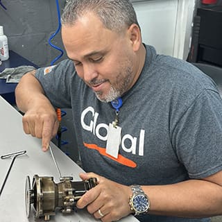 Global AirServices, LLC technicians working on aircraft components